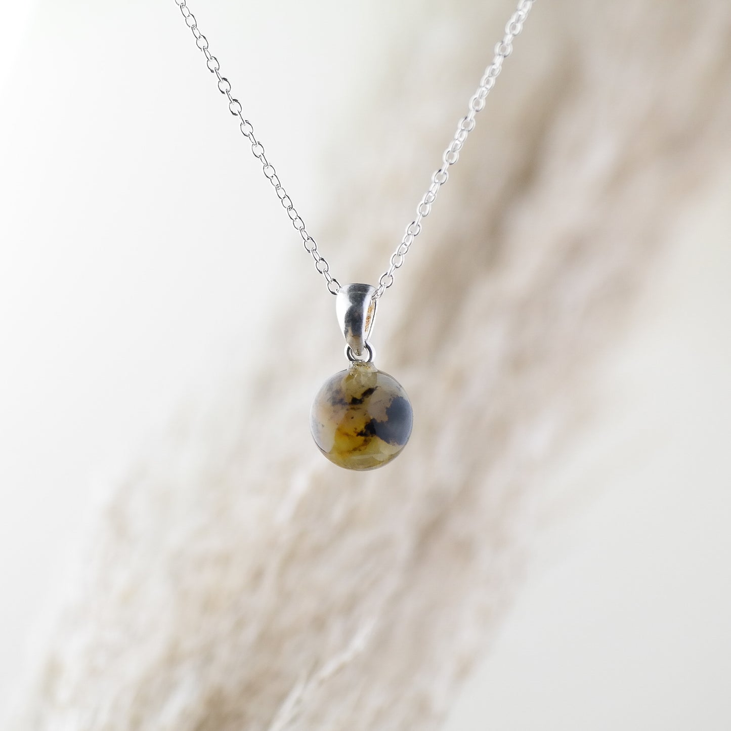 Tiny round amber pendant