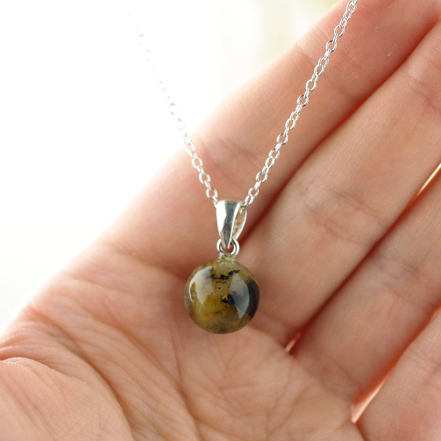 Tiny round amber pendant