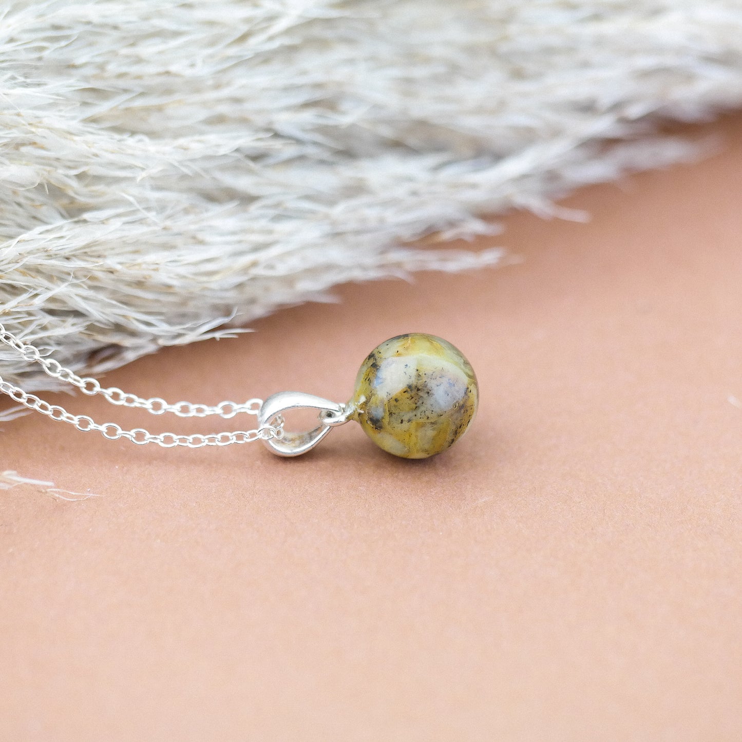 Tiny round amber pendant