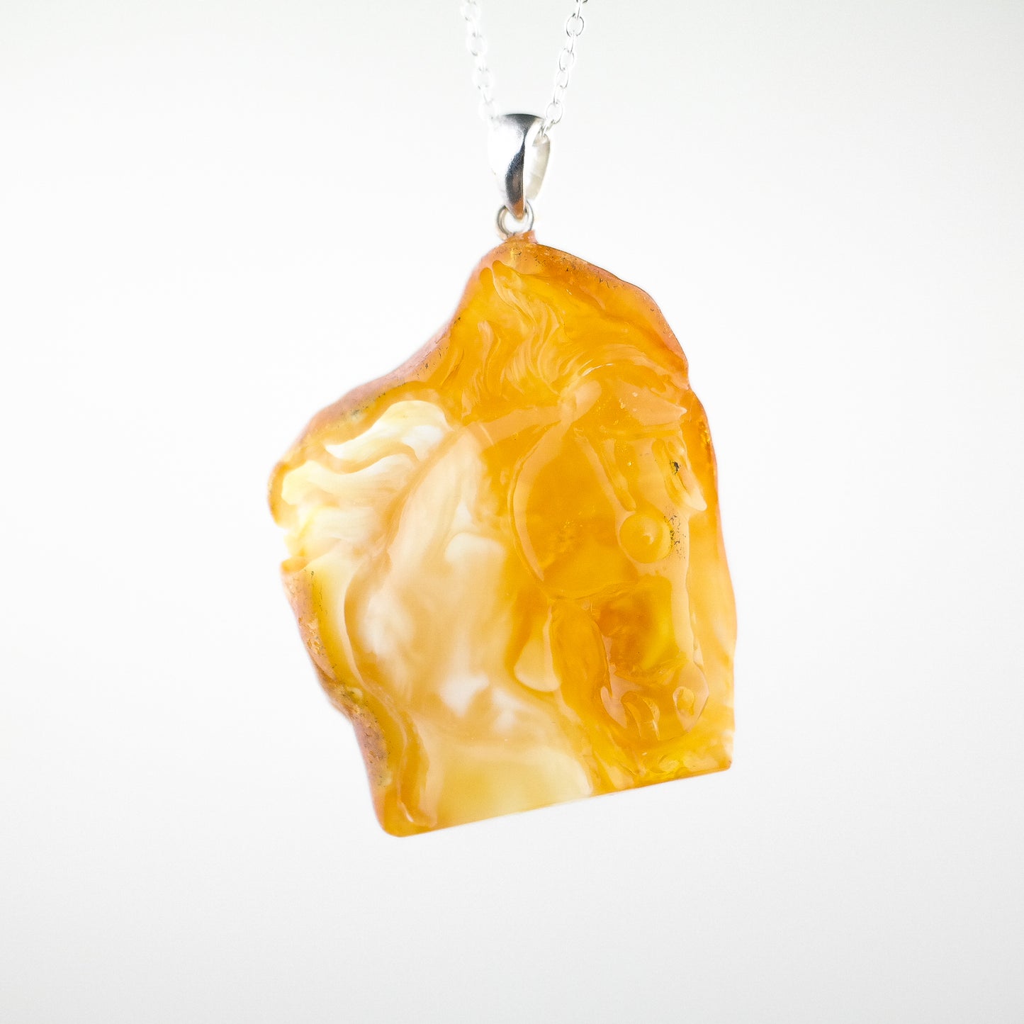 Horse head pendant from natural Baltic amber