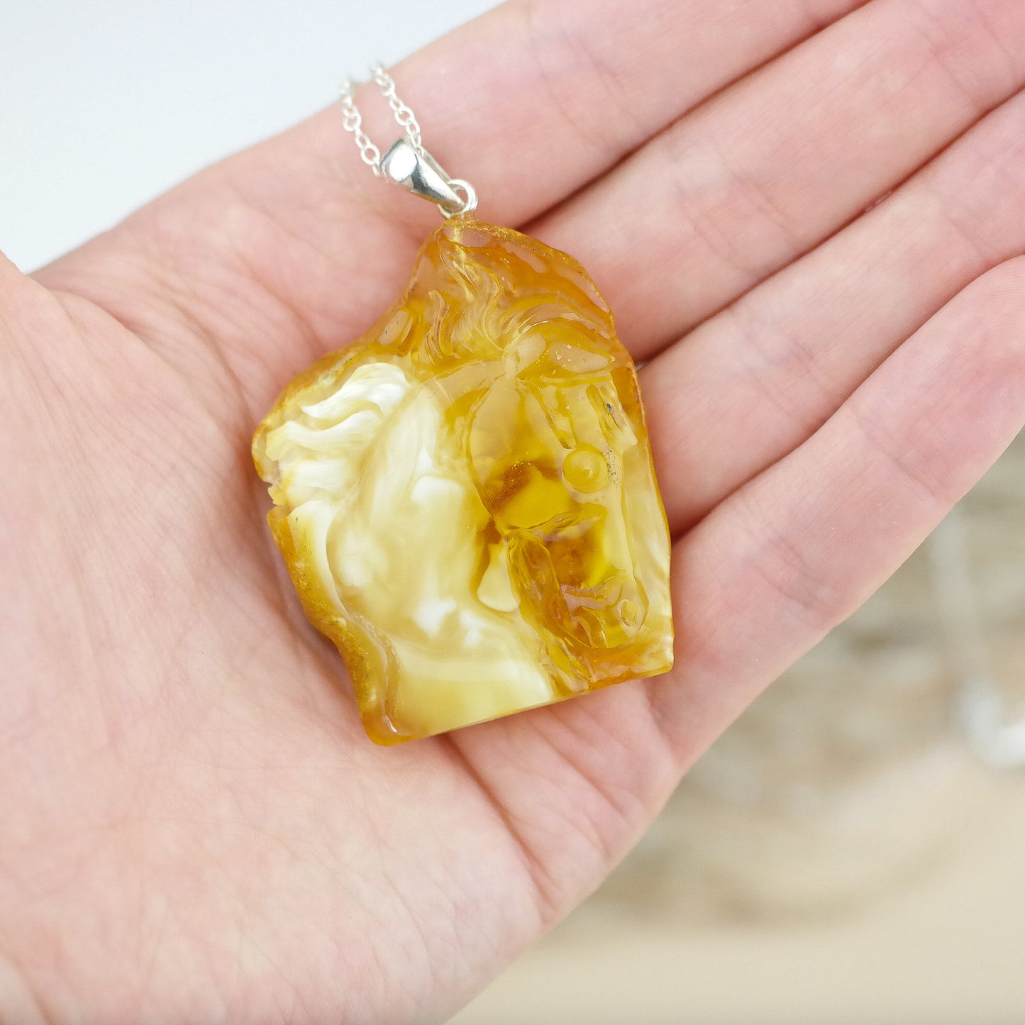 Horse head pendant from natural Baltic amber