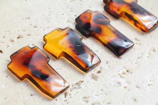 Hand carved crosses from natural Baltic amber