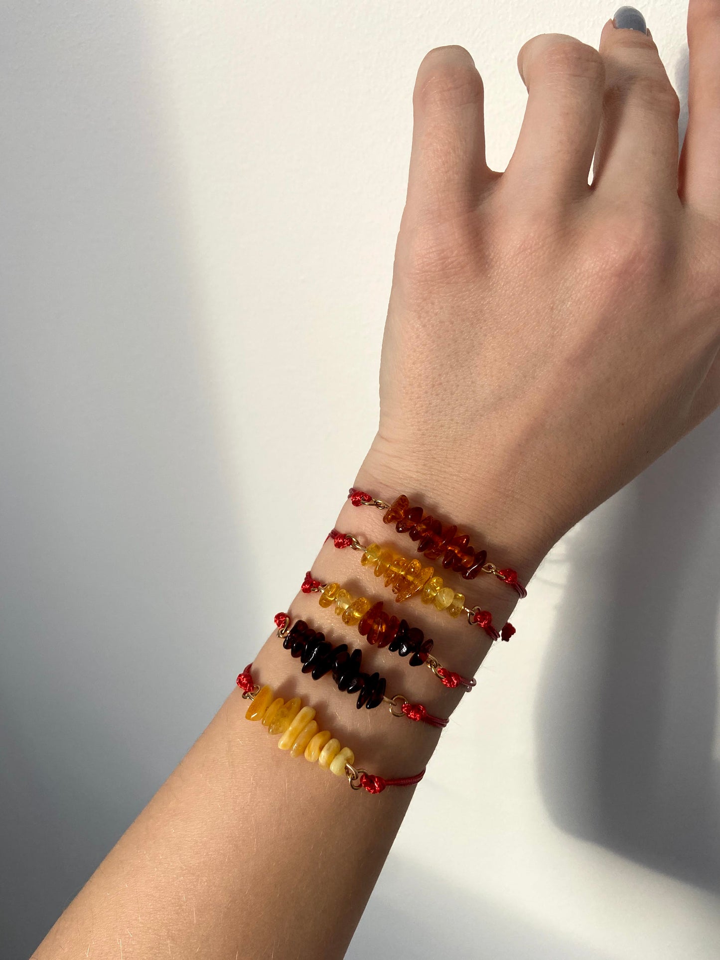 Red thread bracelet with natural Baltic amber