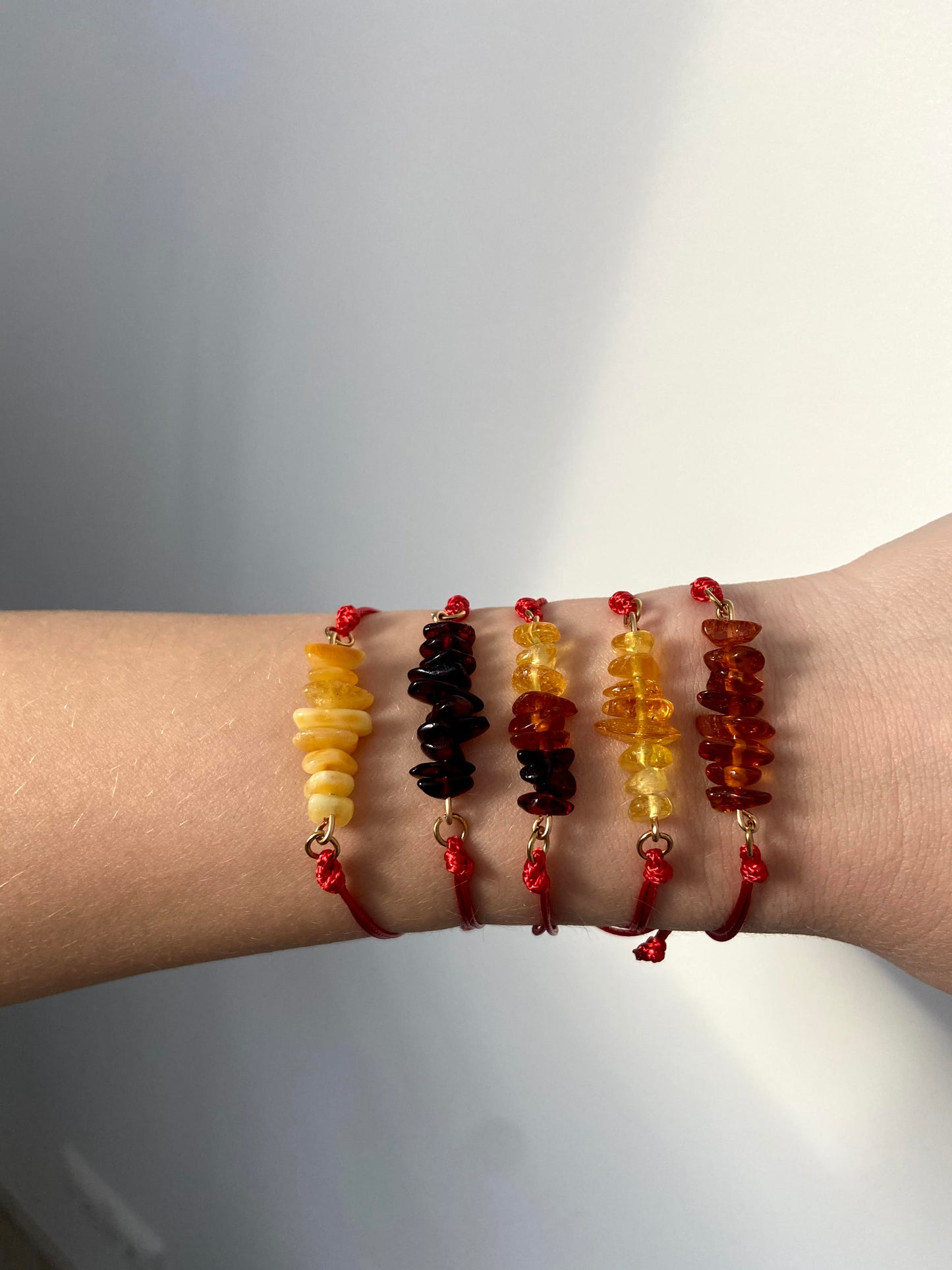 Red thread bracelet with natural Baltic amber