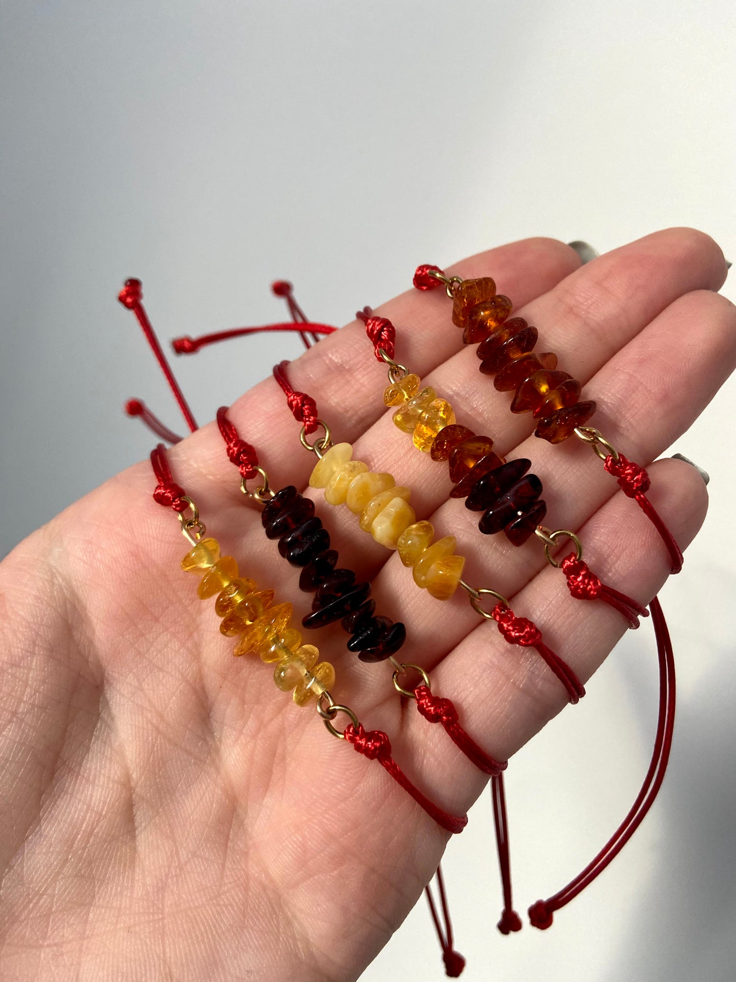 Red thread bracelet with natural Baltic amber