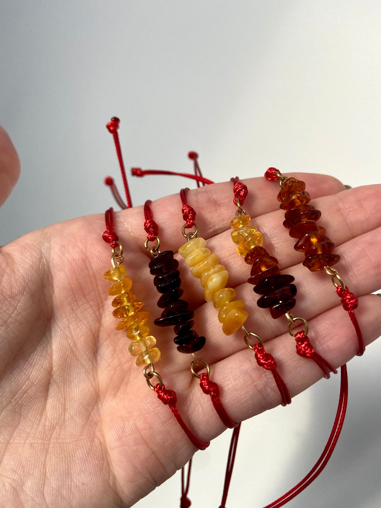 Red thread bracelet with natural Baltic amber