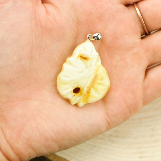 Hand carved amber pendant