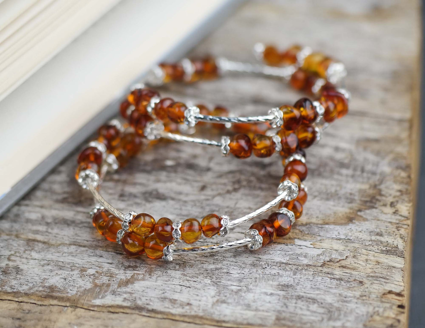 Silver colour bracelets with amber beads