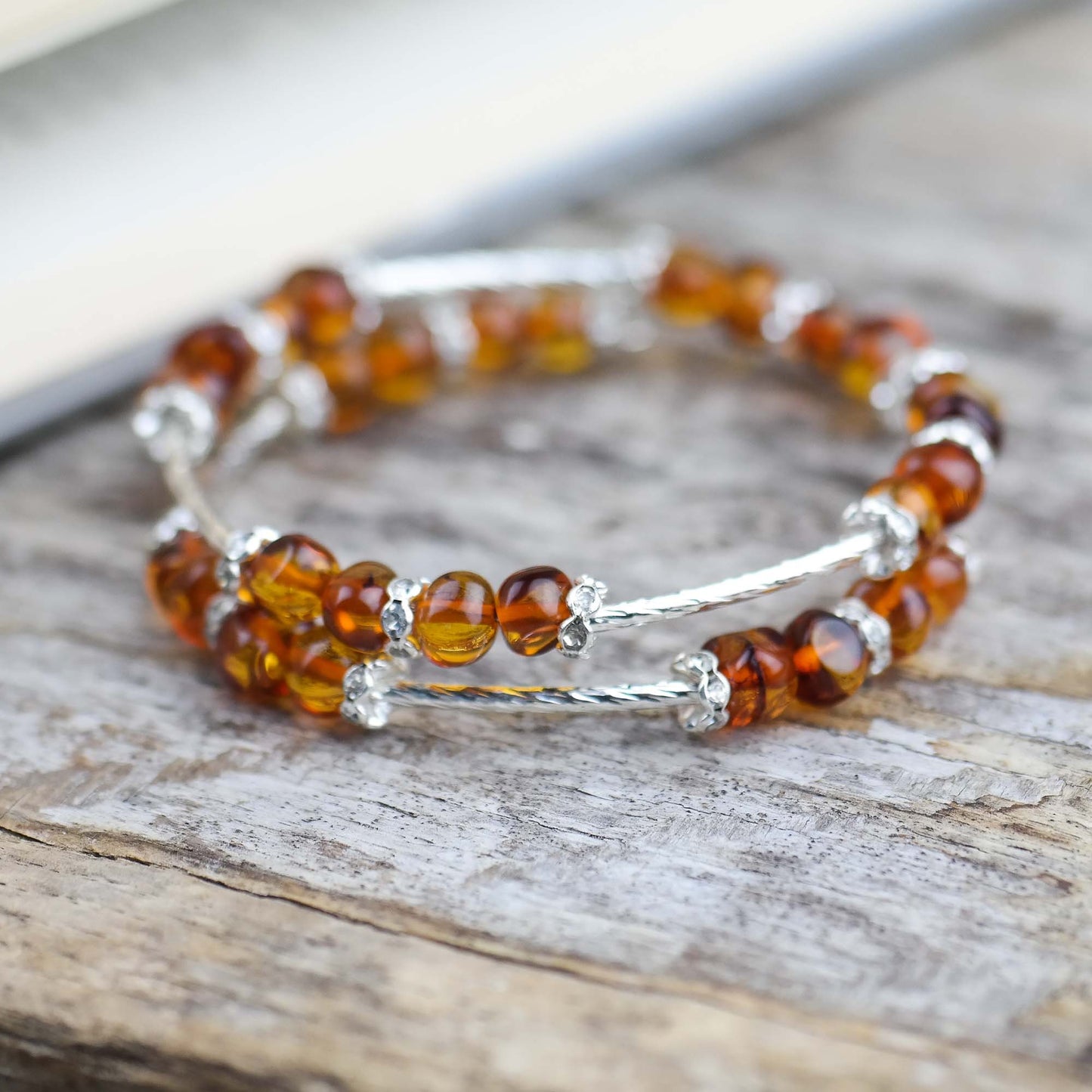 Silver colour bracelets with amber beads