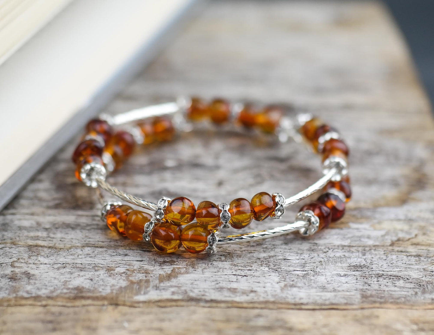 Silver colour bracelets with amber beads