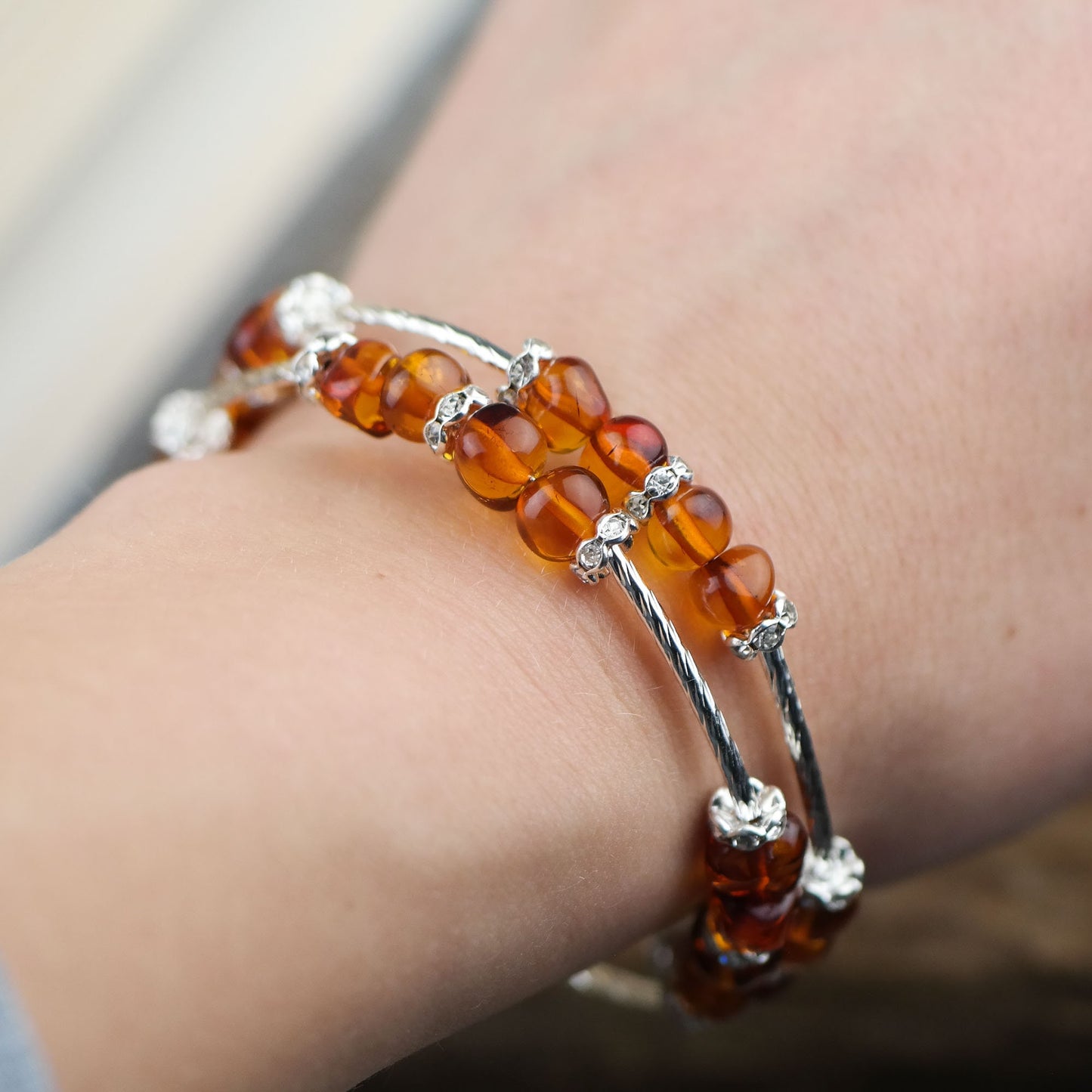 Silver colour bracelets with amber beads