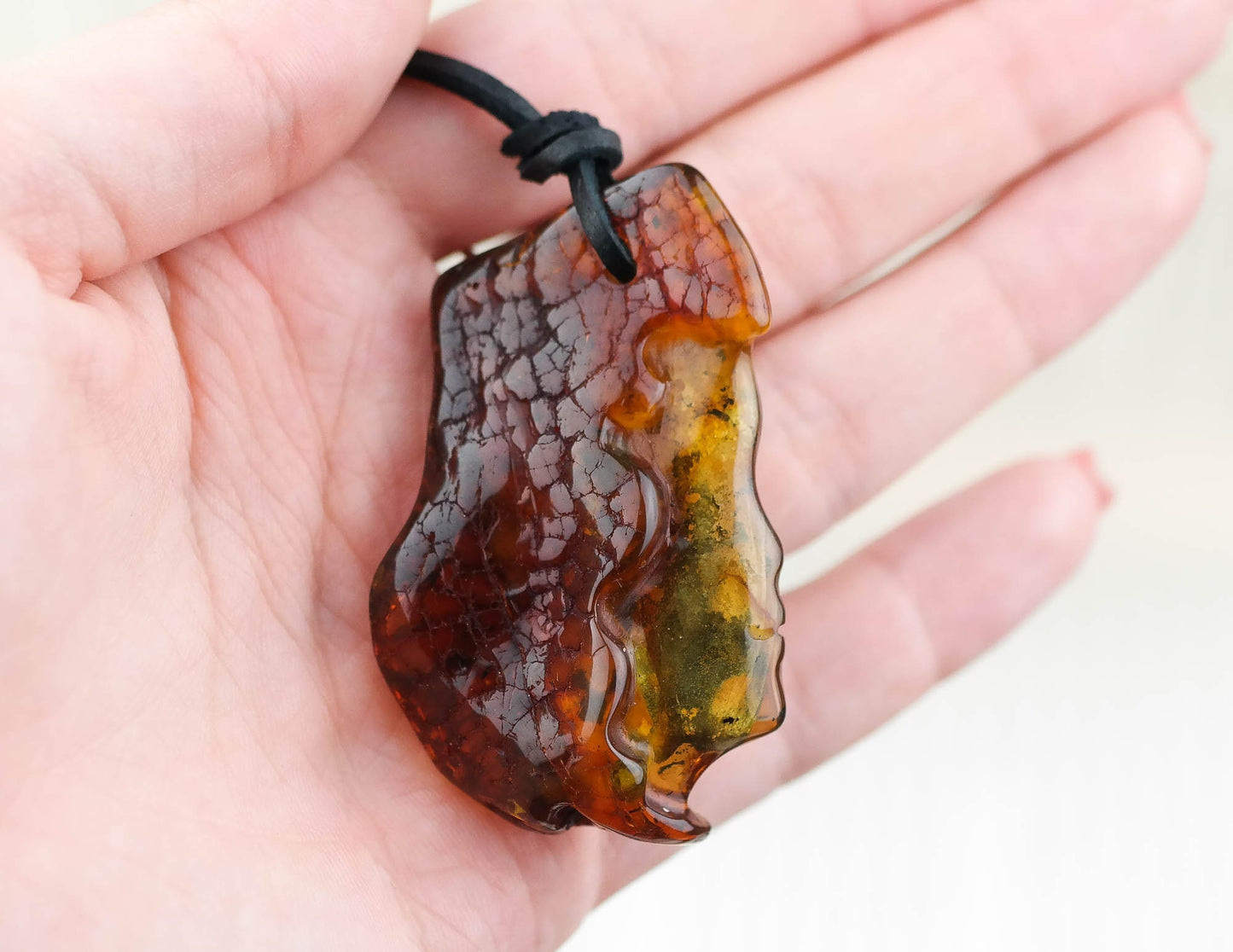 Women face natural amber pendant