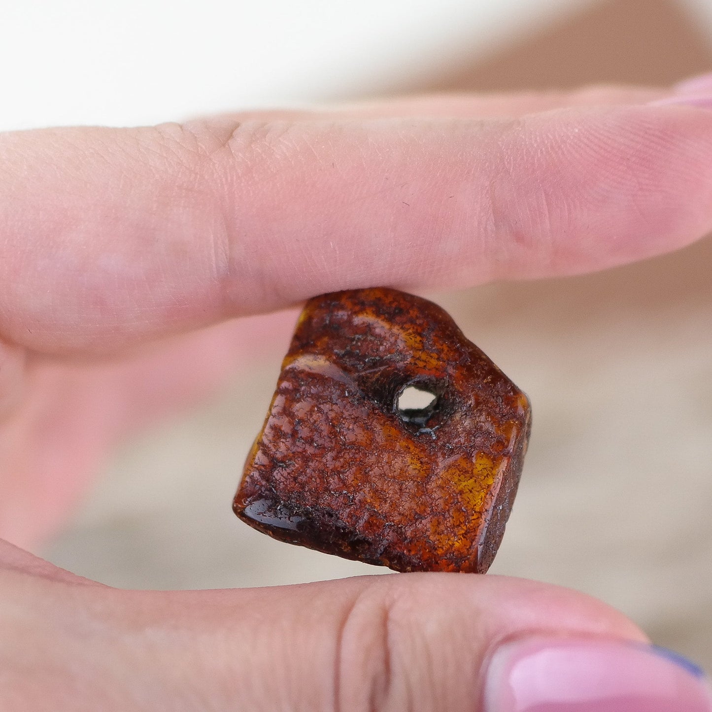 Lucky amber piece with natural hole